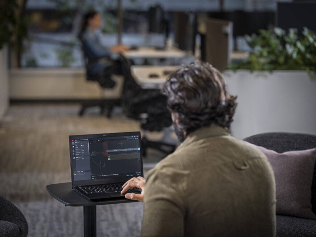 People using AutoCAD in an office environment.