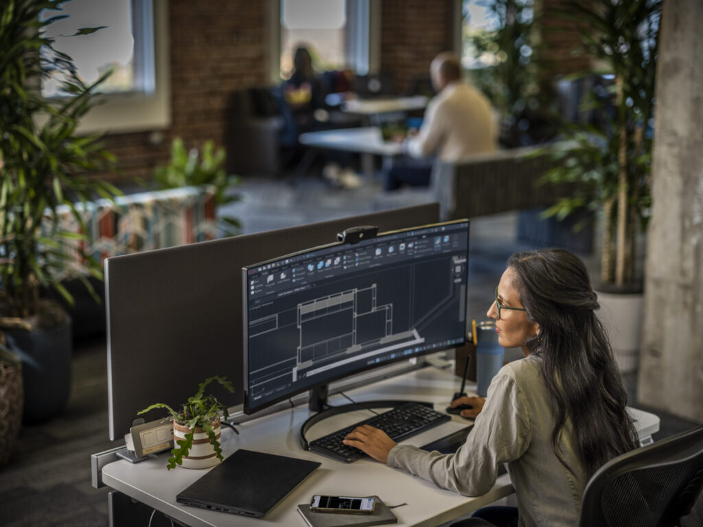 People using AutoCAD in an office environment.