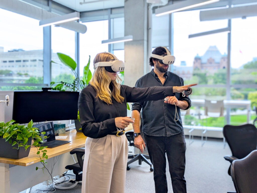 Two people in office with VR headsets