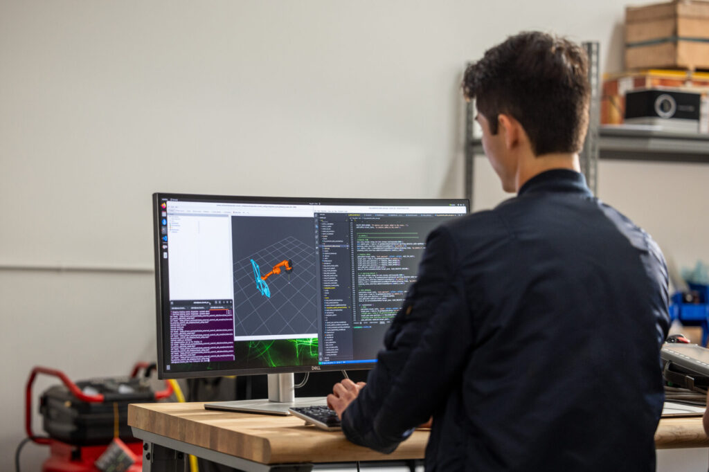 Man using Autodesk Inventor for mechanical design.