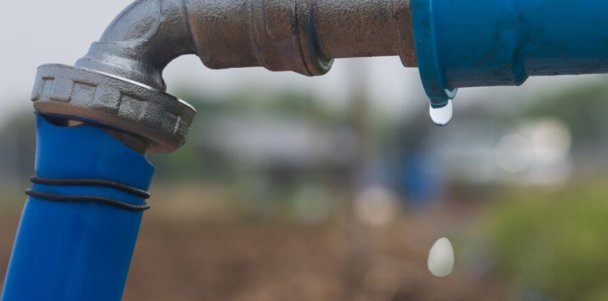 a drop of water leaking from a pipe connection