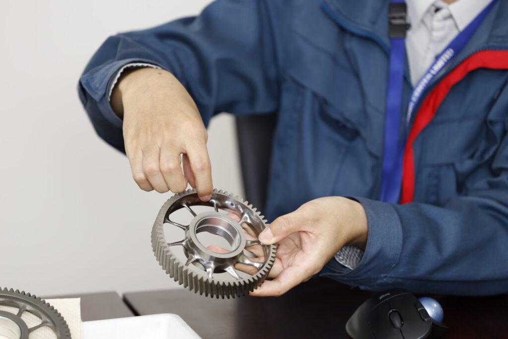 Engineer holding ISUZU gear design